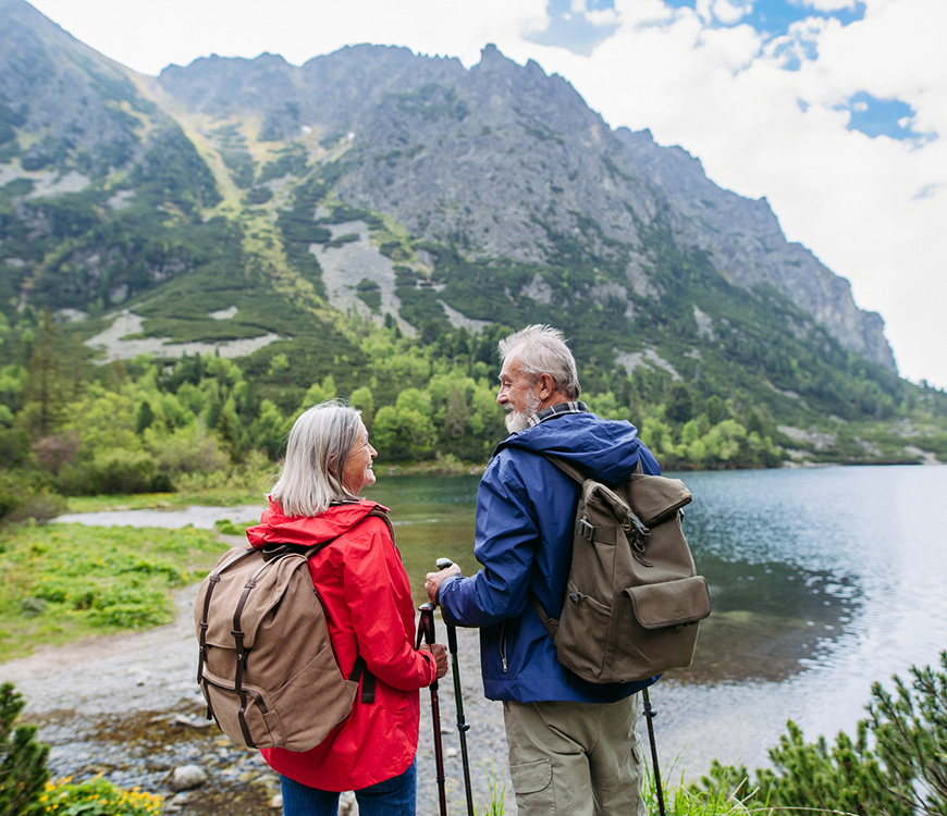 An elderly couple hiking in the mountains