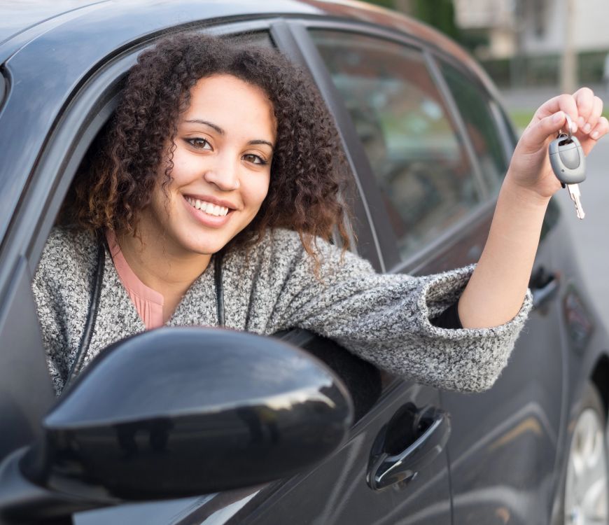 Woman in Murray, UT smiling after purchasing insurance for her new car