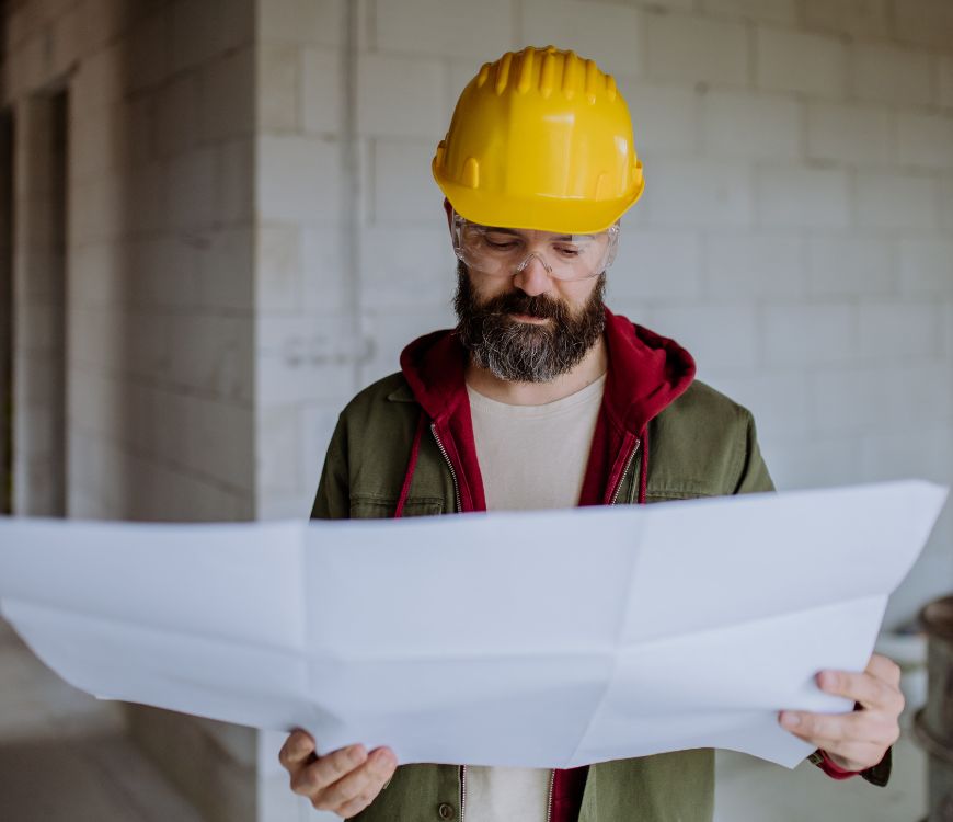 Contractor reviewing a project blueprint