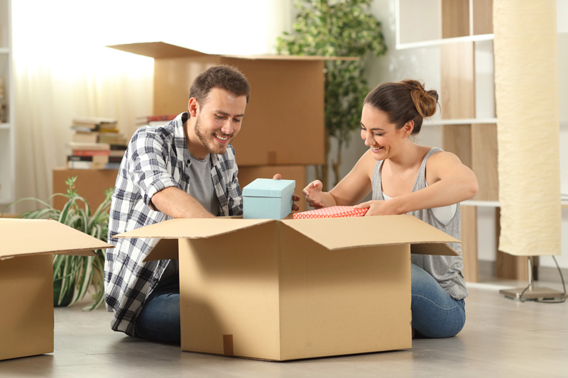 couple unpacking moving boxes in their rental with Renters & Landlord Insurance in Salt Lake City, Murray, Riverton, Sandy, West Valley City, UT