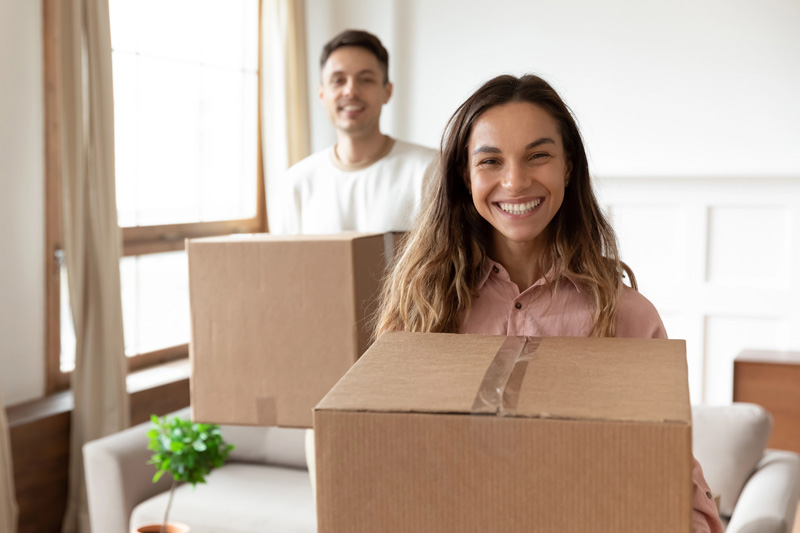 couple moving boxes in their new rental unit with Renters & Landlord Insurance in Salt Lake City, Murray, Riverton, Sandy, West Valley City, UT