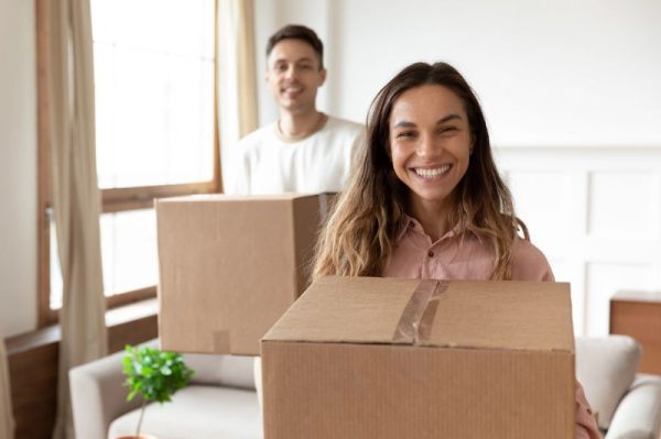 Renters in Sandy, UT smiling after moving into a new apartment with rental insurance